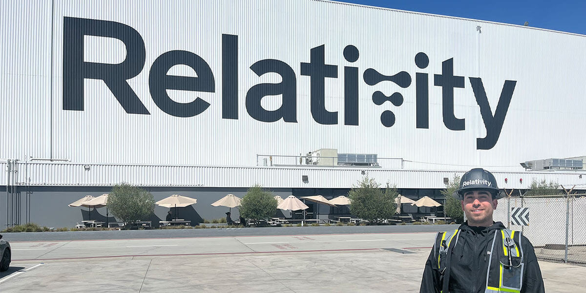 Alex Gasca standing in front of Relativity Space company building